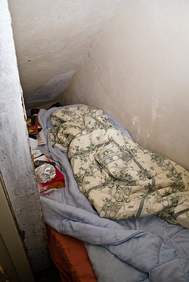 Sleeping space under the stairs in a house packed full of Polish workers.