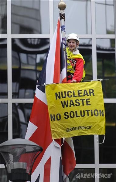 Greenpeace activist climbed into a flagpole holding a banner 'nuclear waste, no solution'...